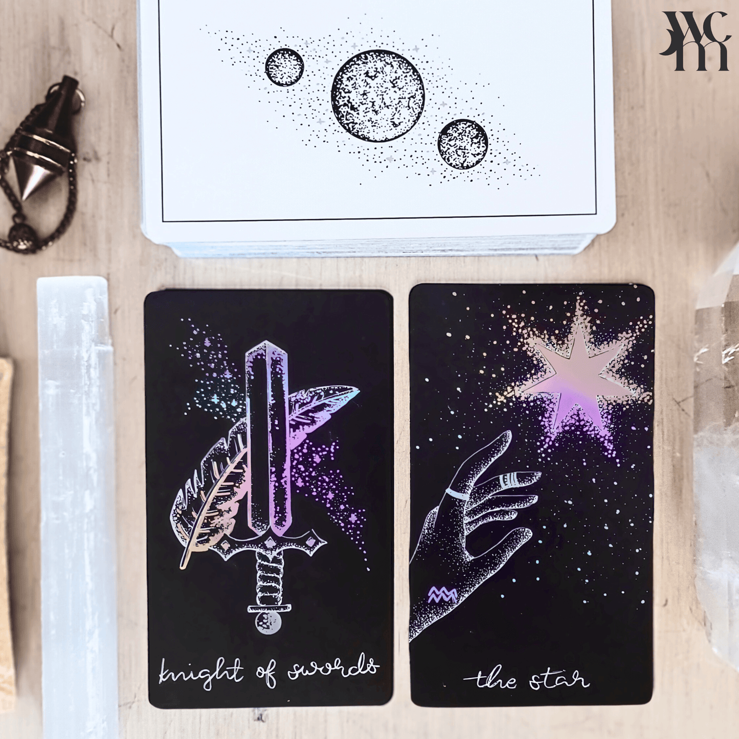 tarot cards with cleansing items, divination tools, resting on wooden surface in natural lighting
