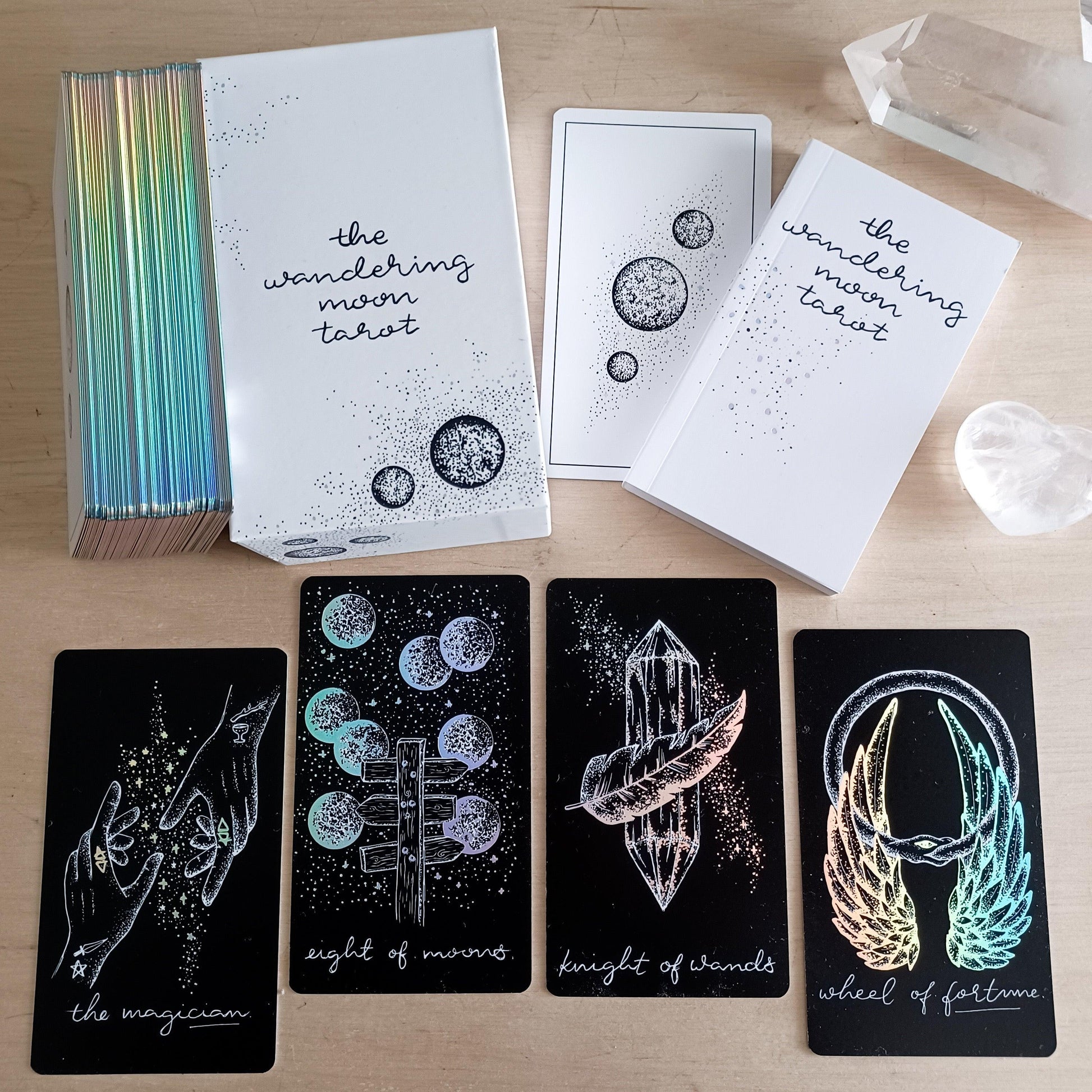 shows entire Midnight Sky tarot pack: guidebook, luxe box, black holo tarot cards, hand illustrated