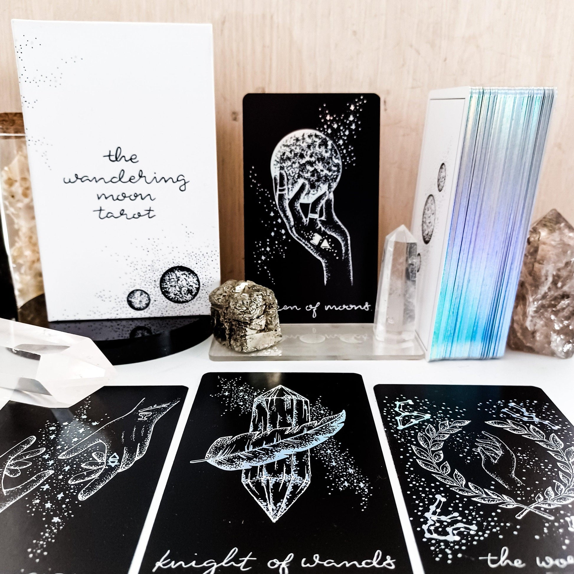 tarot cards laying in foreground with box, deck, booklet upright, from Midnight Sky tarot deck