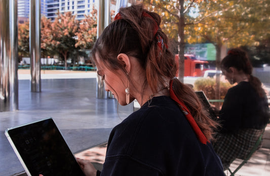 woman sitting while using laptop