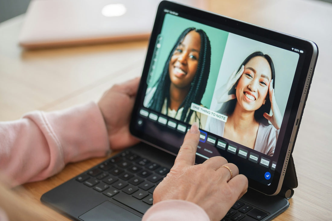 Editing video of two happy women on a digital tablet