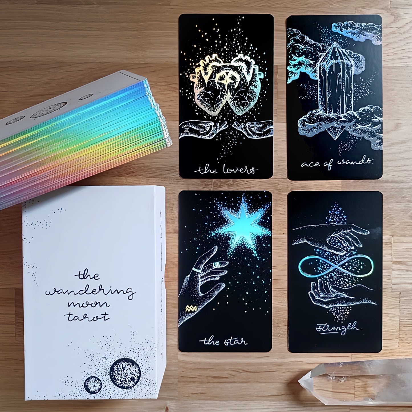 tarot cards, aesthetic: black tarot card art with holographic details & guidebook