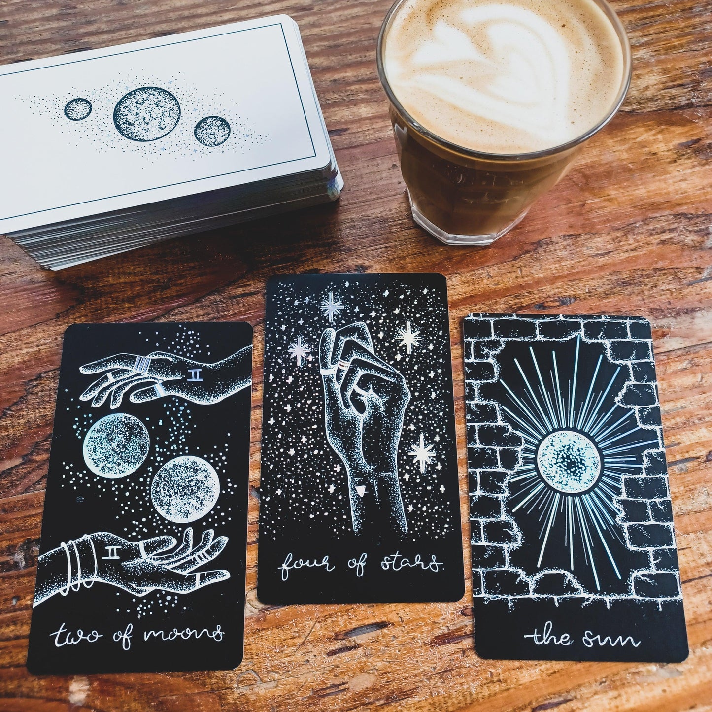 coffee cup with tarot cards from Midnight Sky indie deck on wooden surface